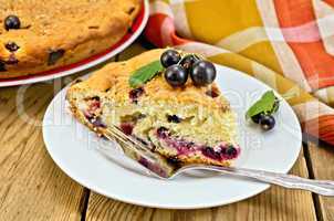 pie with black currant on the board with a fork