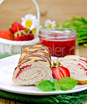 Roulade with strawberries and daisies on a board