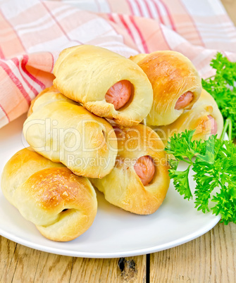 Sausage rolls with parsley on the board