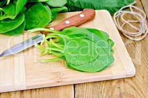 Spinach on the board with a knife