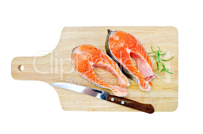 Trout on the board with a knife and rosemary