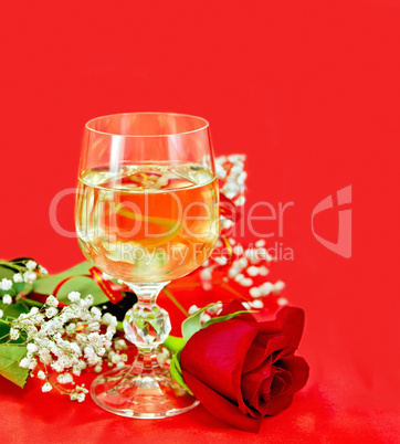 Wine in a glass with a rose