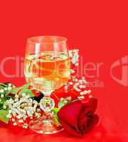 Wine in a glass with a rose