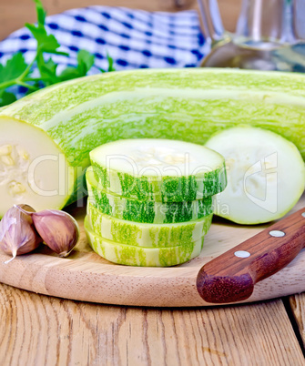 Zucchini green with garlic on a board