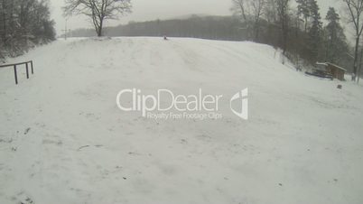 Mother and daughter sledding at winter