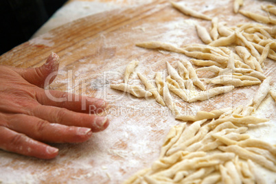 Strozzapreti homemade on wooden table