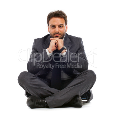 Young businessman sitting on the ground