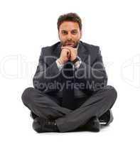 Young businessman sitting on the ground