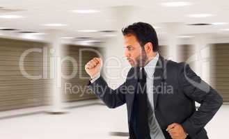 Businessman running in office because it is late