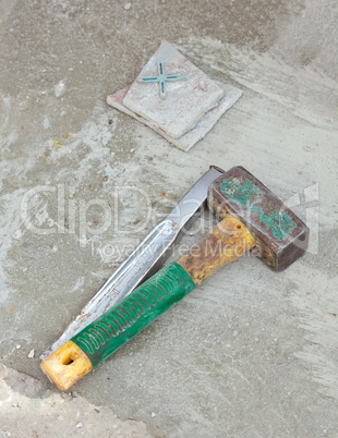 Awl and hammer on concrete flooring