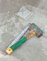 Awl and hammer on concrete flooring