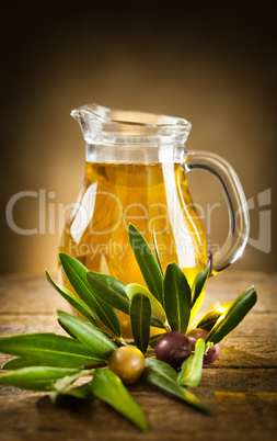 Bottle of olive oil and an olive branch