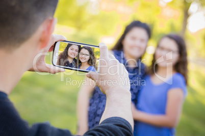 Man Takes Cell Phone Picture of Wife and Daughter