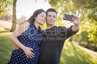 Pregnant Wife and Husband Taking Cell Phone Picture of Themselve