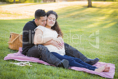 Pregnant Hispanic Couple in The Park Outdoors