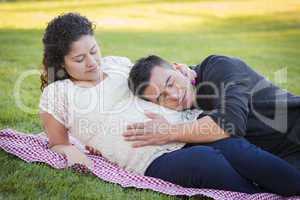 Pregnant Hispanic Couple in The Park Outdoors