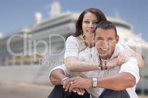 Young Happy Hispanic Couple In Front of Cruise Ship