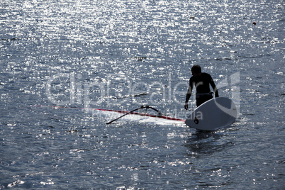 kitesurfer stands in water