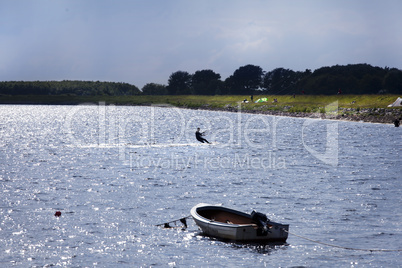 kitesurfer with motorboat