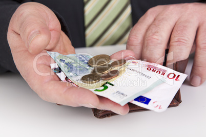 businessman showing the contents of his wallet
