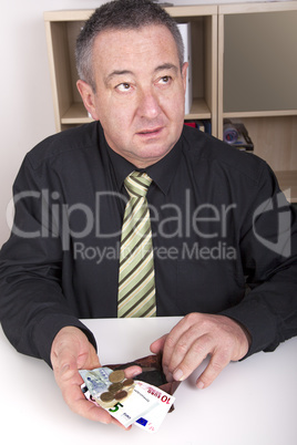 businessman showing the meager contents of his wallet