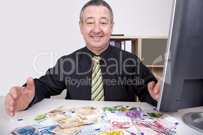 businessman is pleased with his money on the desk