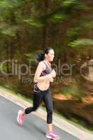 young woman running outdoors motion blur