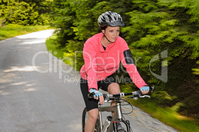 woman mountain biking motion blur cycling path