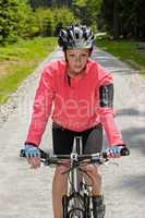 woman riding mountain bike sunny countryside path