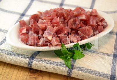 Serrano ham  diced for cooking on a white dish
