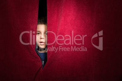 Child appearing beneath the curtain