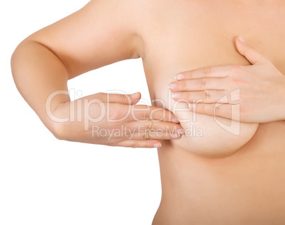 woman examining her breast for lumps