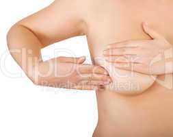 woman examining her breast for lumps
