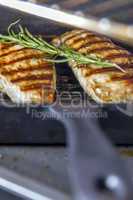 chicken breast with rosemary in pan