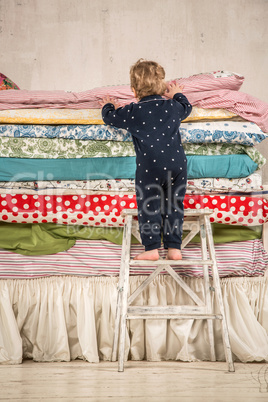 child climbs on the bed - princess and the pea.