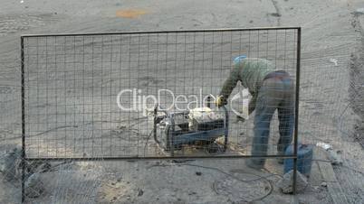 Worker launches engine of electrical generator