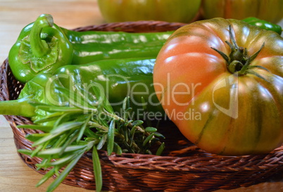 Tomato and green peppers in a wicker source