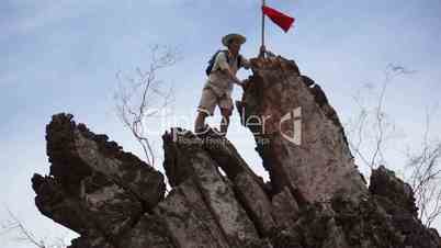 male climber with red flag