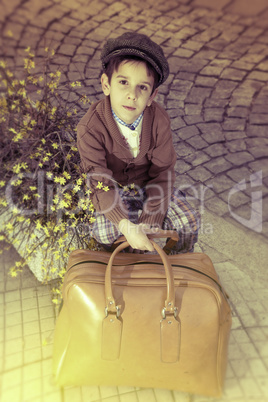 Child on a road with vintage bag