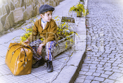 Child on a road with vintage bag