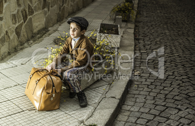 Child on a road with vintage bag