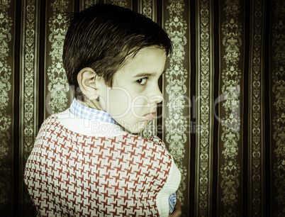 Frowning child vintage clothes.