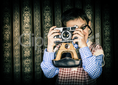 Child taking pictures with vintage camera