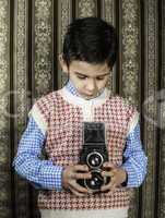 Child taking pictures with vintage camera