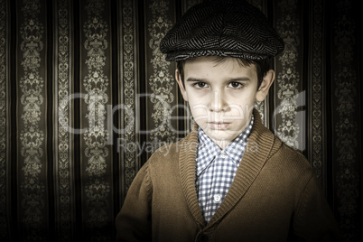 Frowning child in vintage clothes and hat
