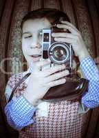 Child taking pictures with vintage camera