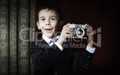 Child taking pictures with vintage camera