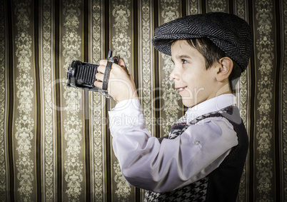 Child taking pictures with vintage camera