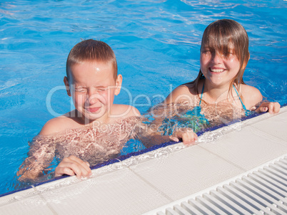 girl and boy in swimming pool