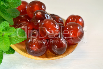 Candied cherries with mint leaves